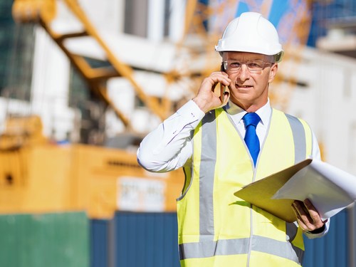 construction supervisor in stafford virginia using his phone and tablet in the field